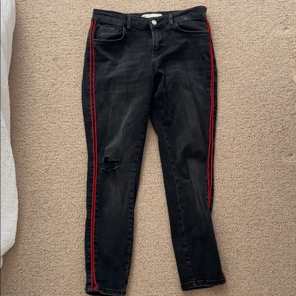 Black jeans with red stripe
